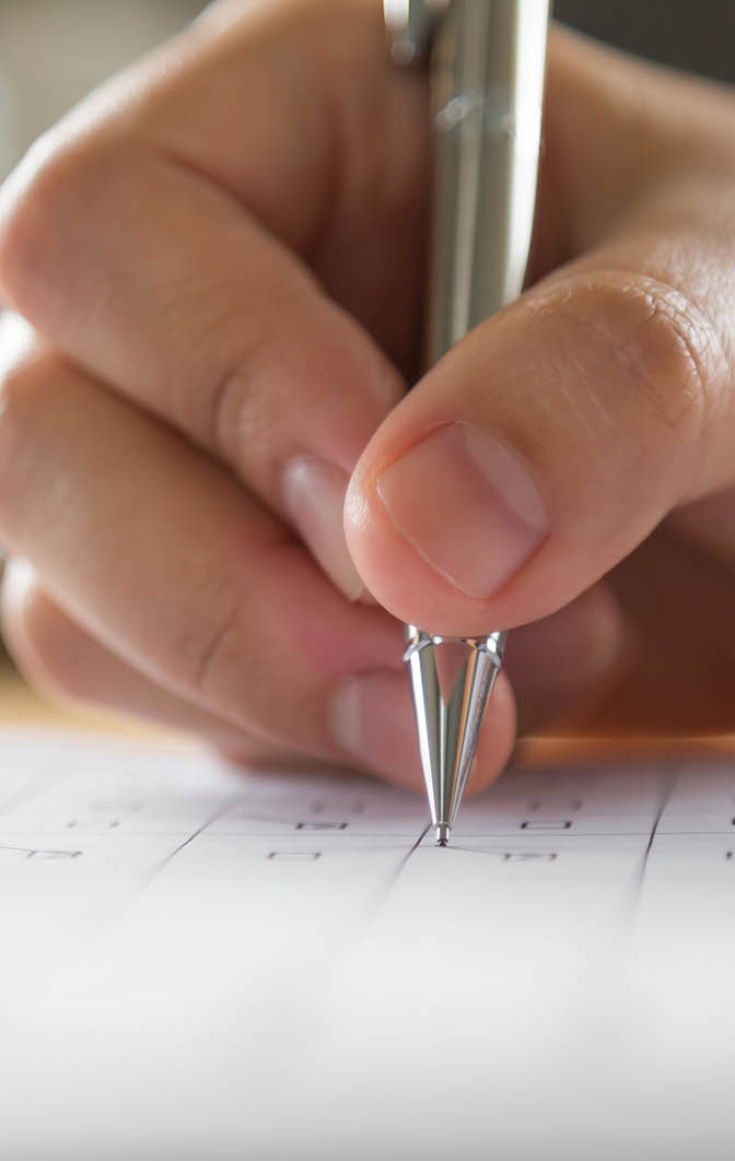 Hand with pen over application form