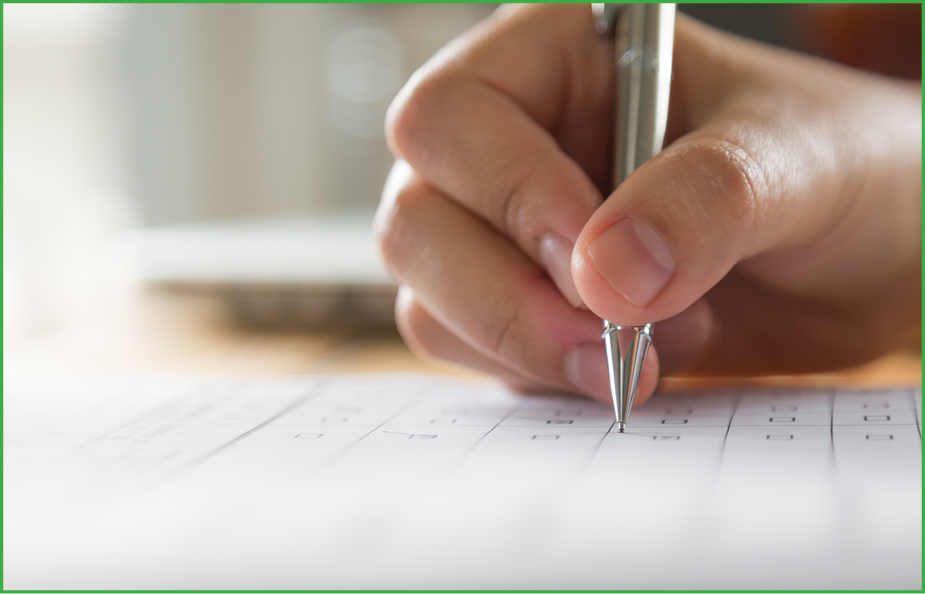 Hand with pen over application form