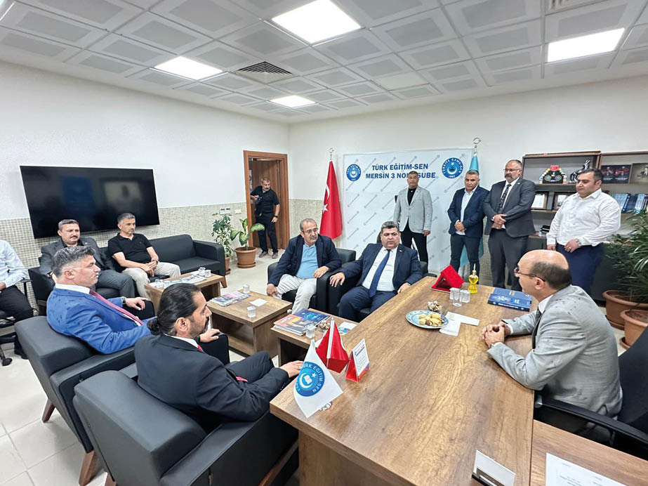 A group of people are sitting around a table. Description generated by AI