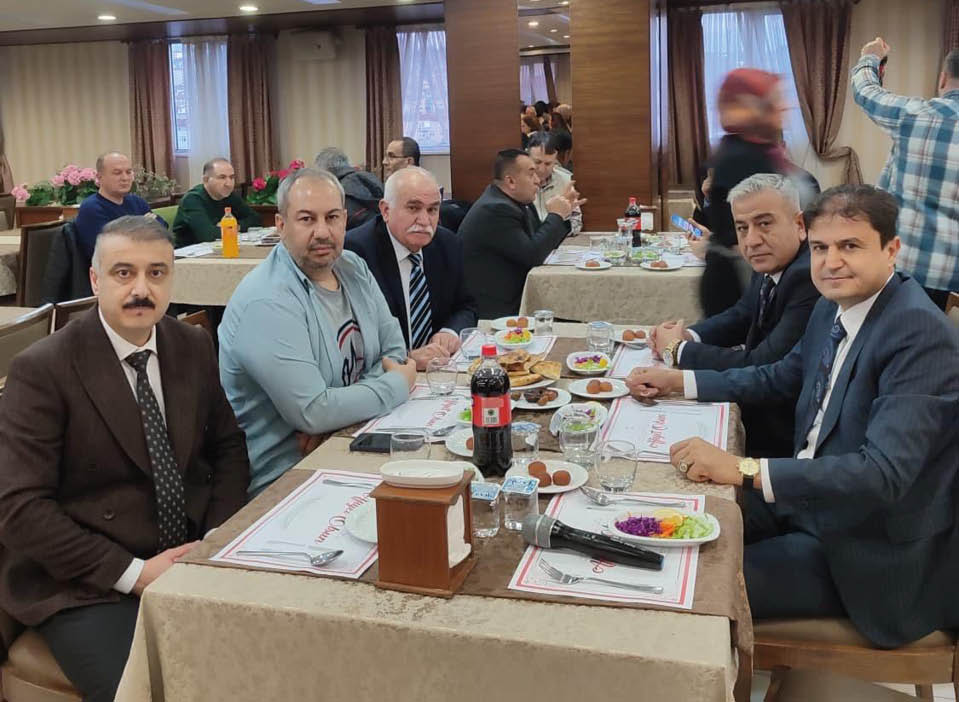 A group of men sitting at a table in a restaurant. Description generated by AI