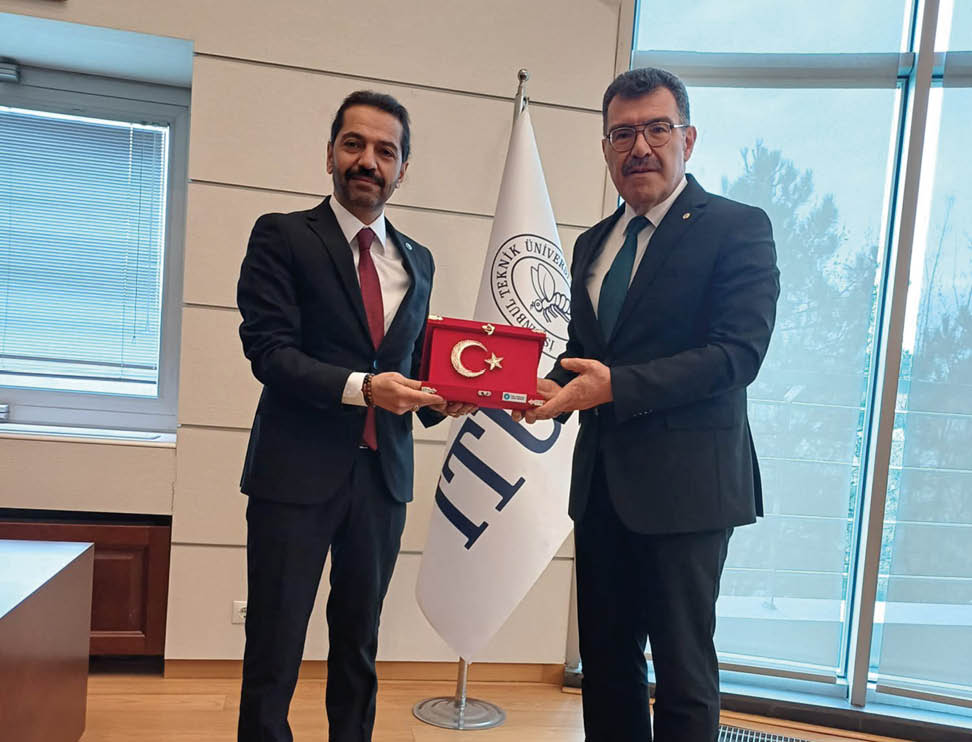 Two men in suits holding a red and white box. Description generated by AI