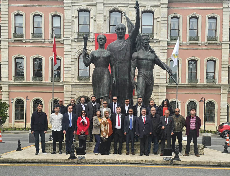 A group of people standing in front of a statue. Description generated by AI