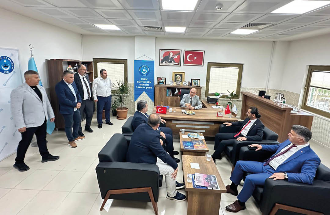 A group of men in suits are sitting around a table. Description generated by AI