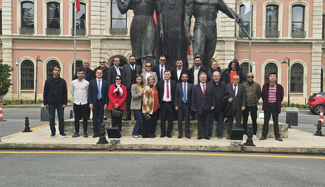 A group of people standing in front of a statue. Description generated by AI
