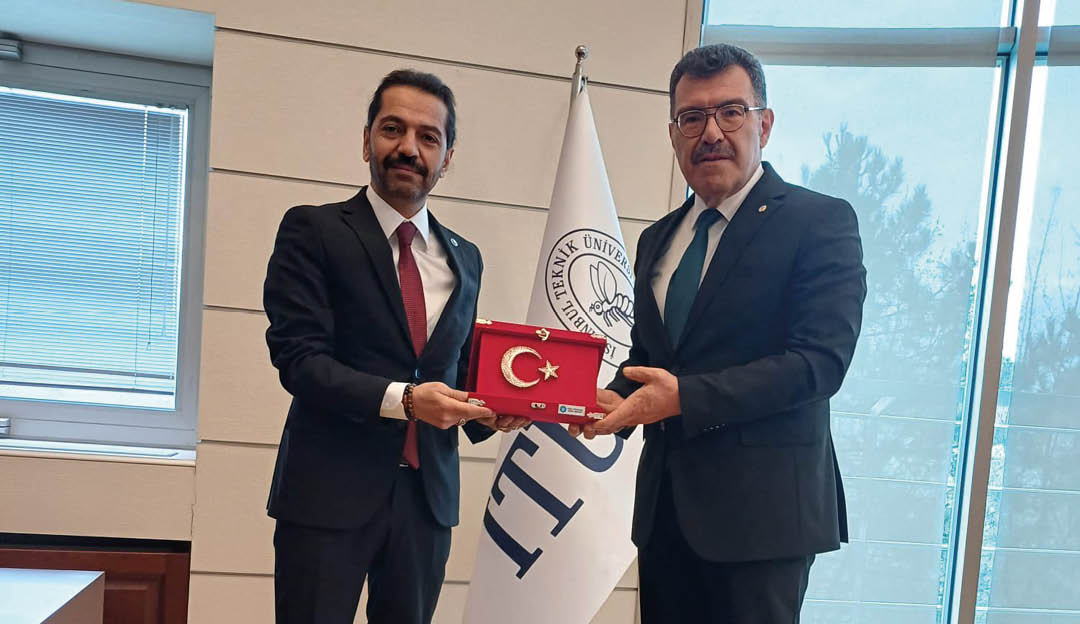 Two men in suits holding a red and white box. Description generated by AI